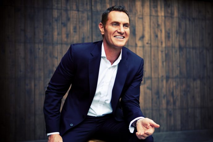 Darren Hardy in Front of a Wooden Background