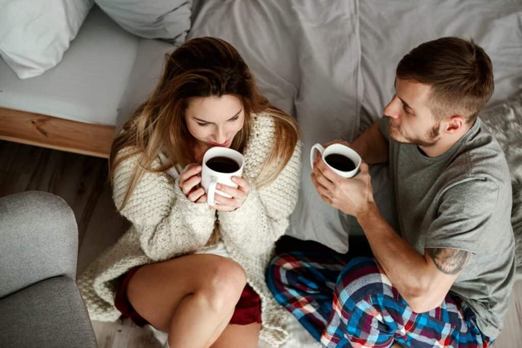couple talking and drinking coffee at home