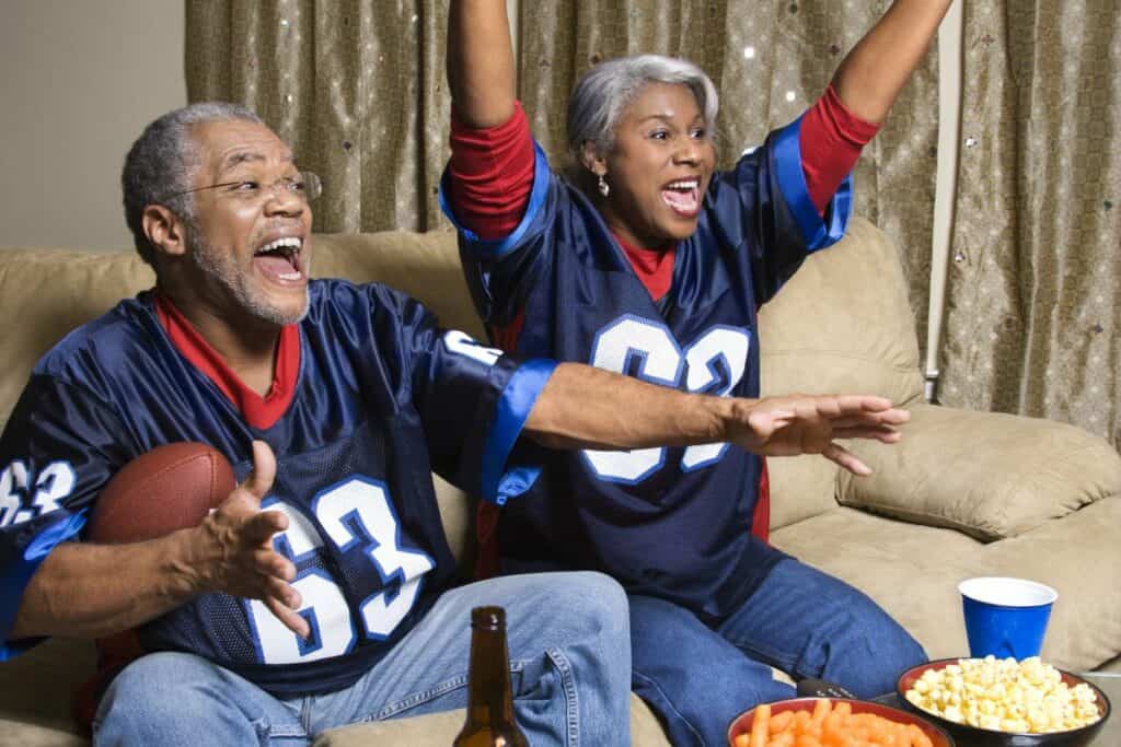 older couple watching a sports game as an at home date idea
