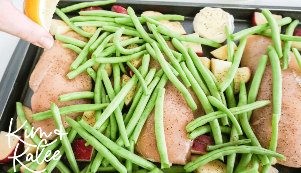 Making a one pan dinner of garlic chicken, green beans and red potatoes