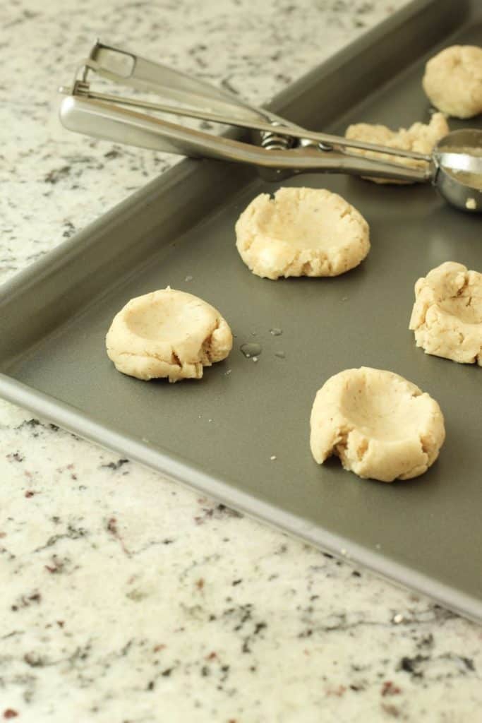 thumbprint cookies on a cookie sheet