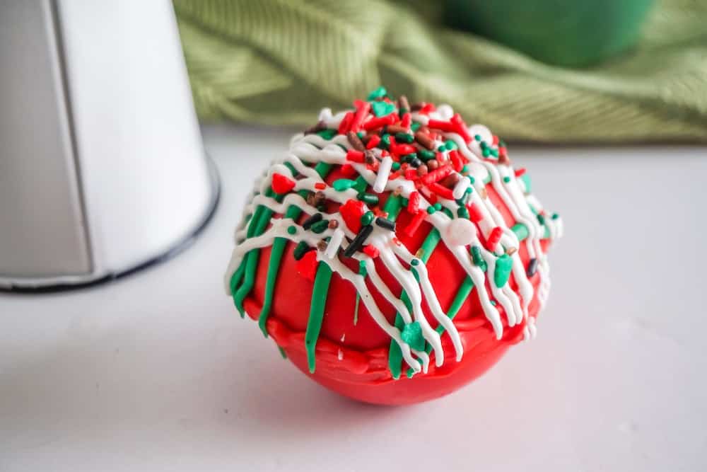 red hot chocolate bomb with green and white decorations