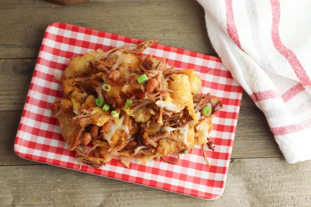 Loaded Pulled Pork Totchos on a red and white plate
