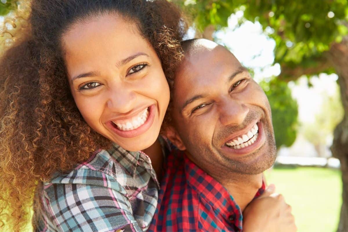 happy black couple smiling into the camera