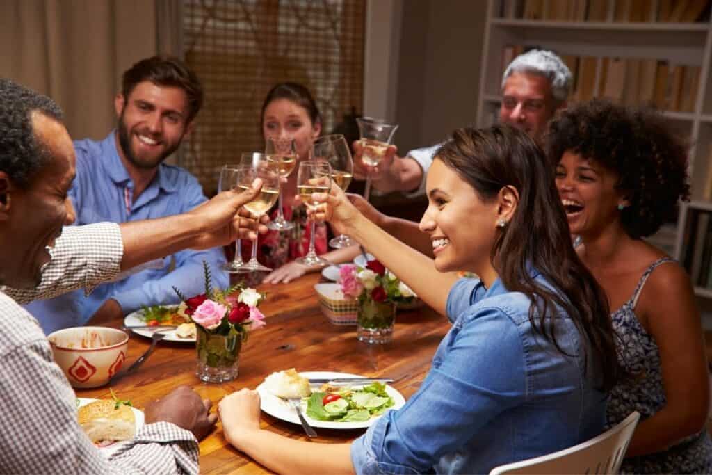 group of friends cheers-ing at dinner