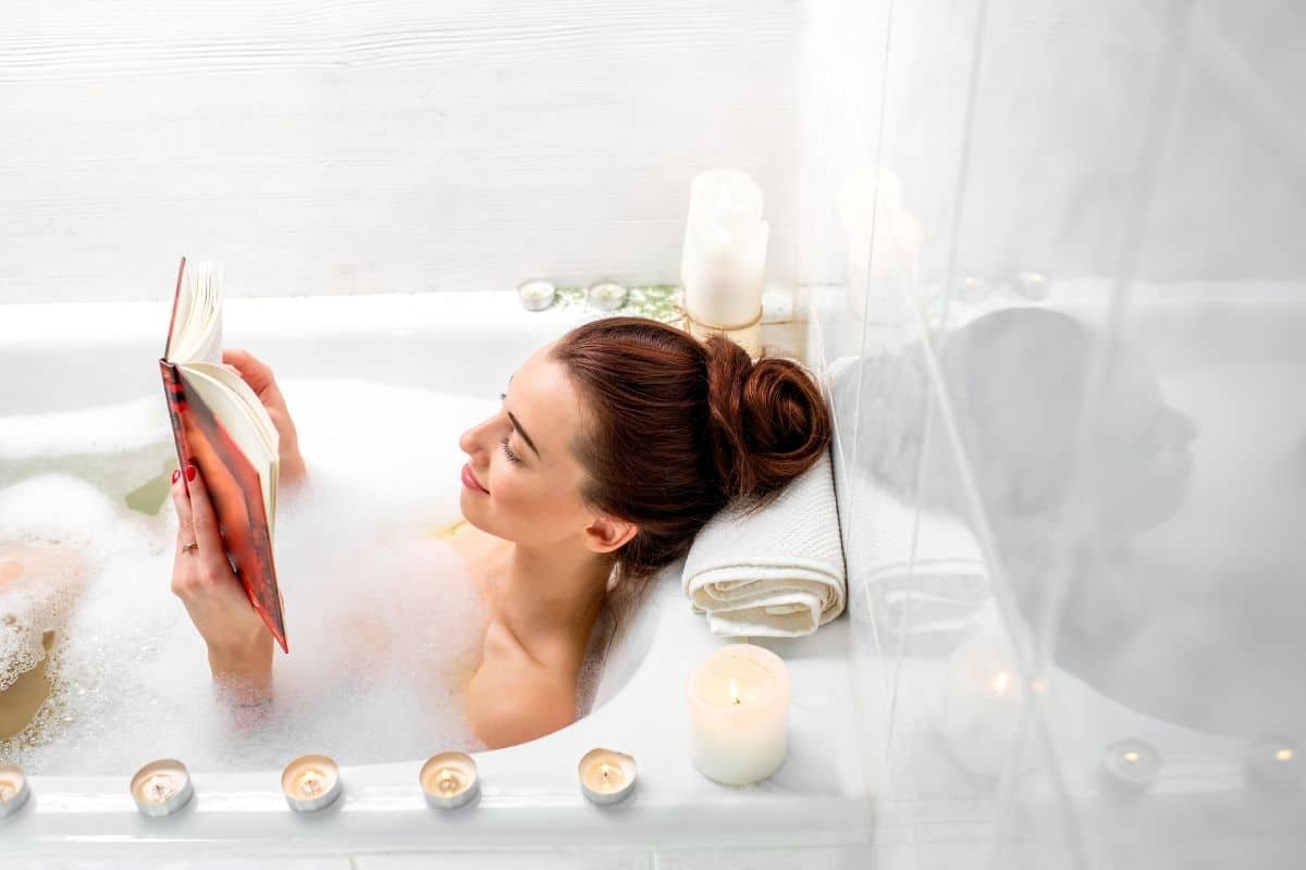 woman in a bubble bath reading