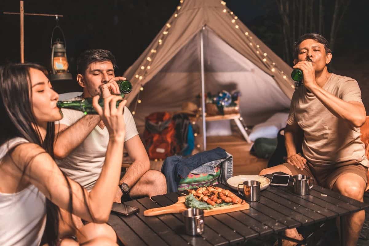 friends camping and drinking