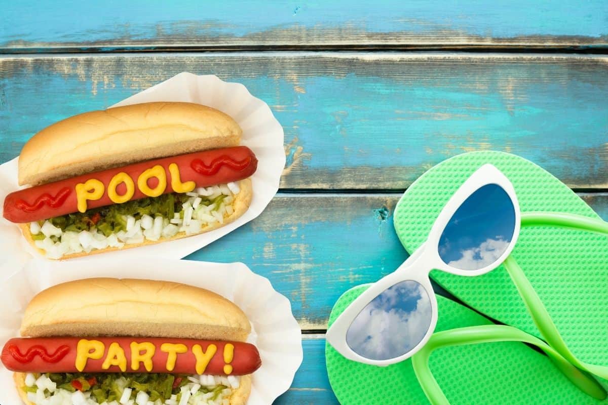 2 hot dogs - POOL and PARTY written in mustard on each one with sunglasses and flip flops