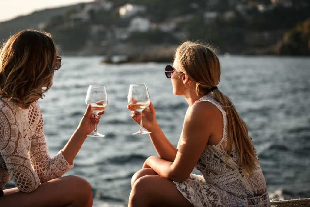friends drinking wine at the beach
