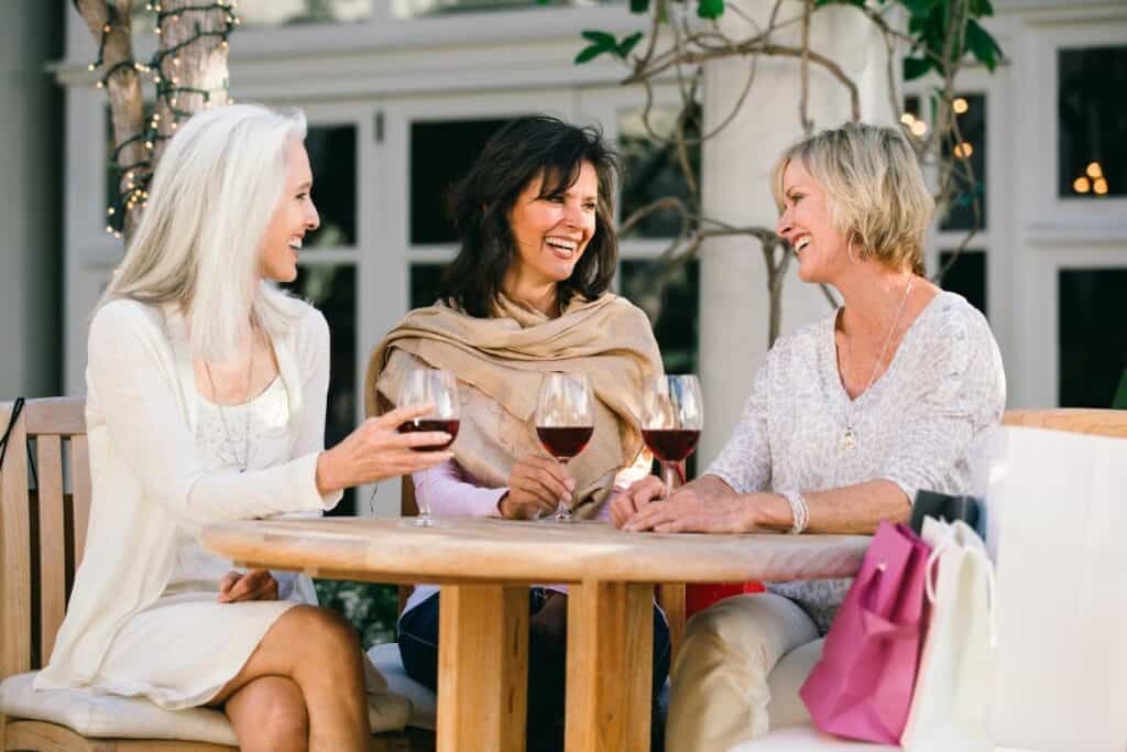 3 older ladies enjoying a glass of wine