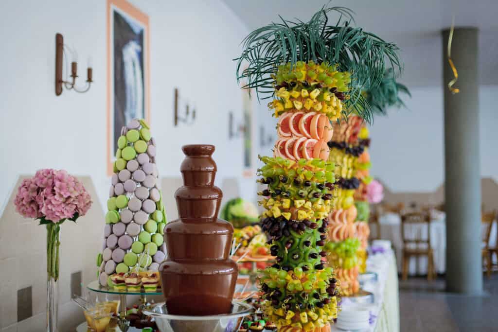 table for a wedding reception with fresh fruit and a chocolate fountain