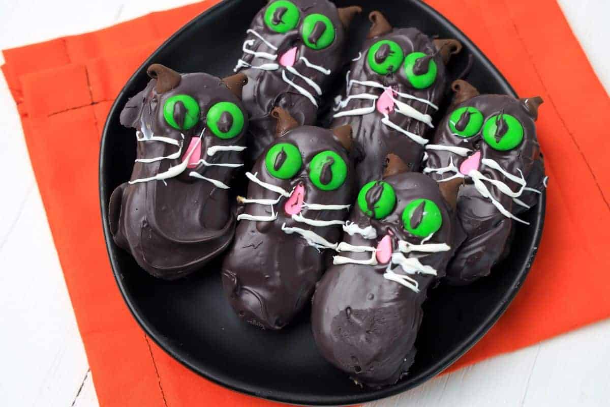 black cat cookies on a plate