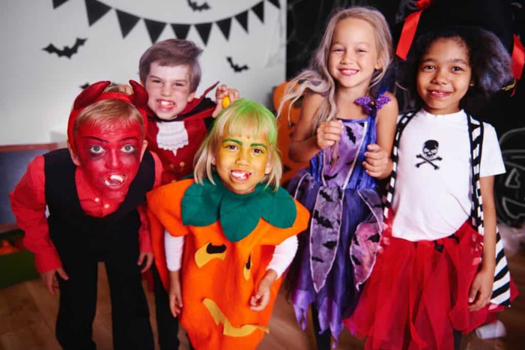 5 little kids dressed up for Halloween