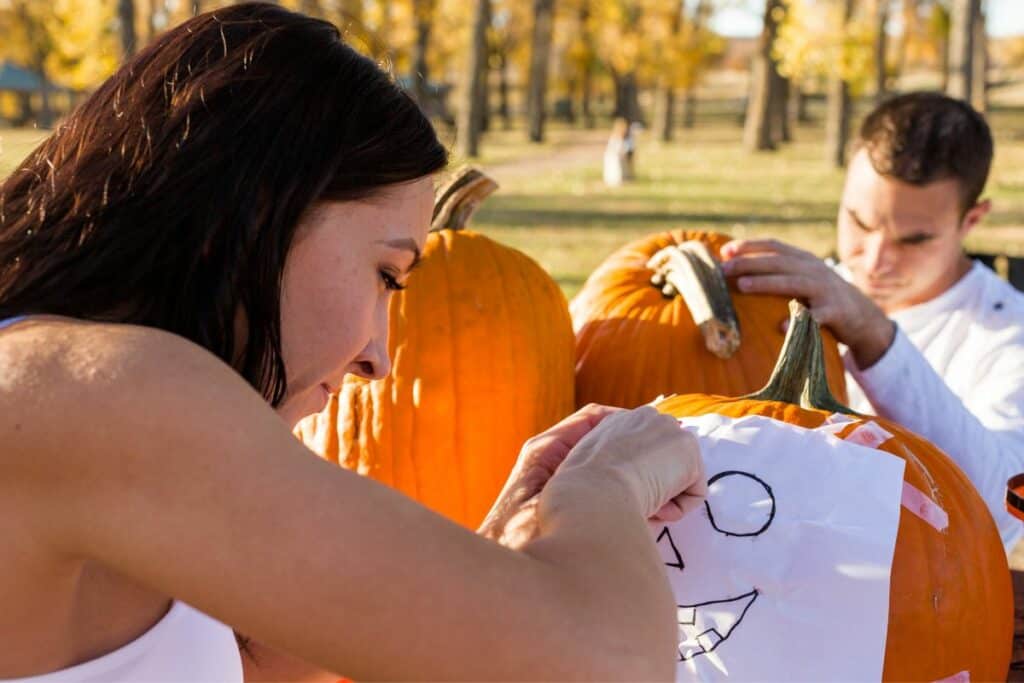 woman carving a pumpkin