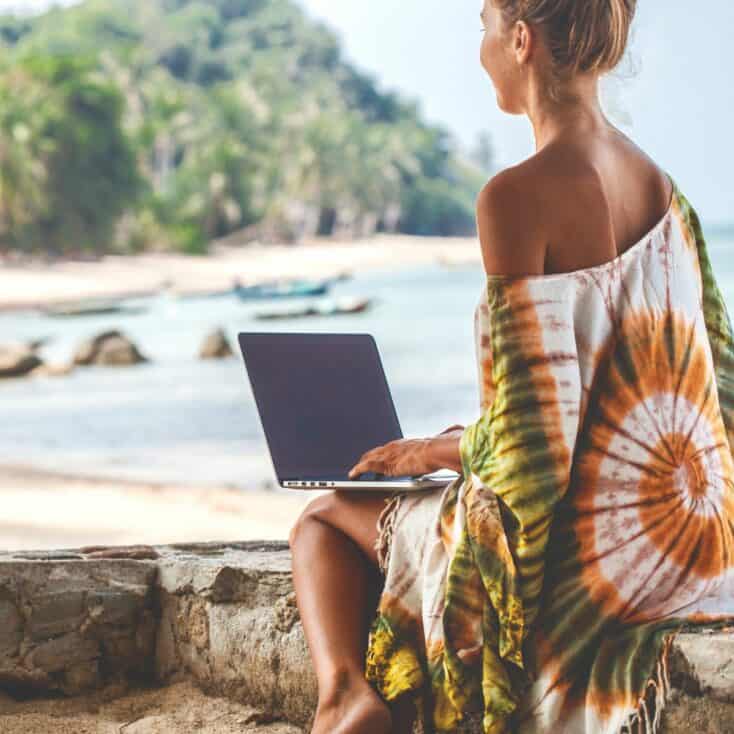 young blogger with her laptop at the beach