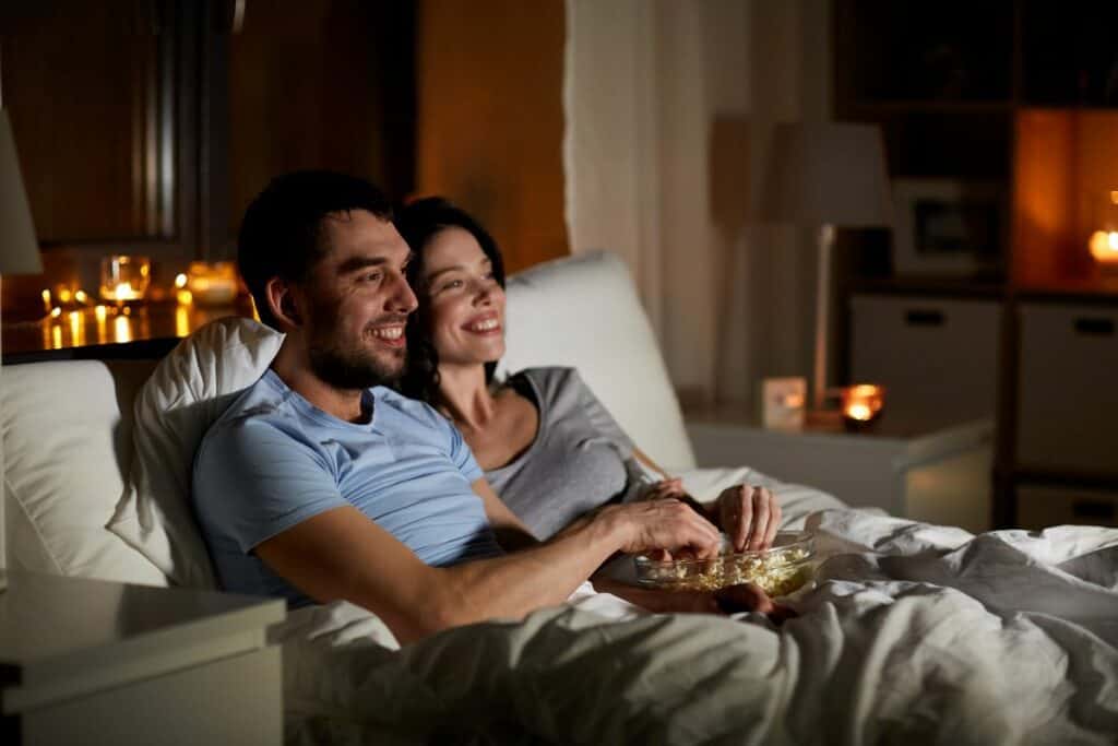 couple enjoying a movie on the couch