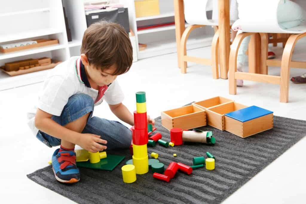 preschool kid stacking blocks
