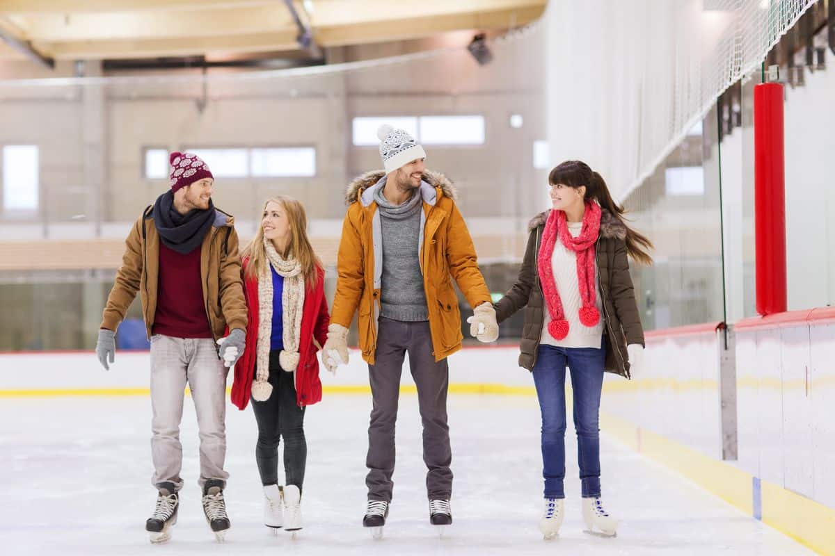 4 teenagers ice skating 