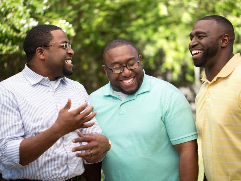group of 3 adult brothers laughing