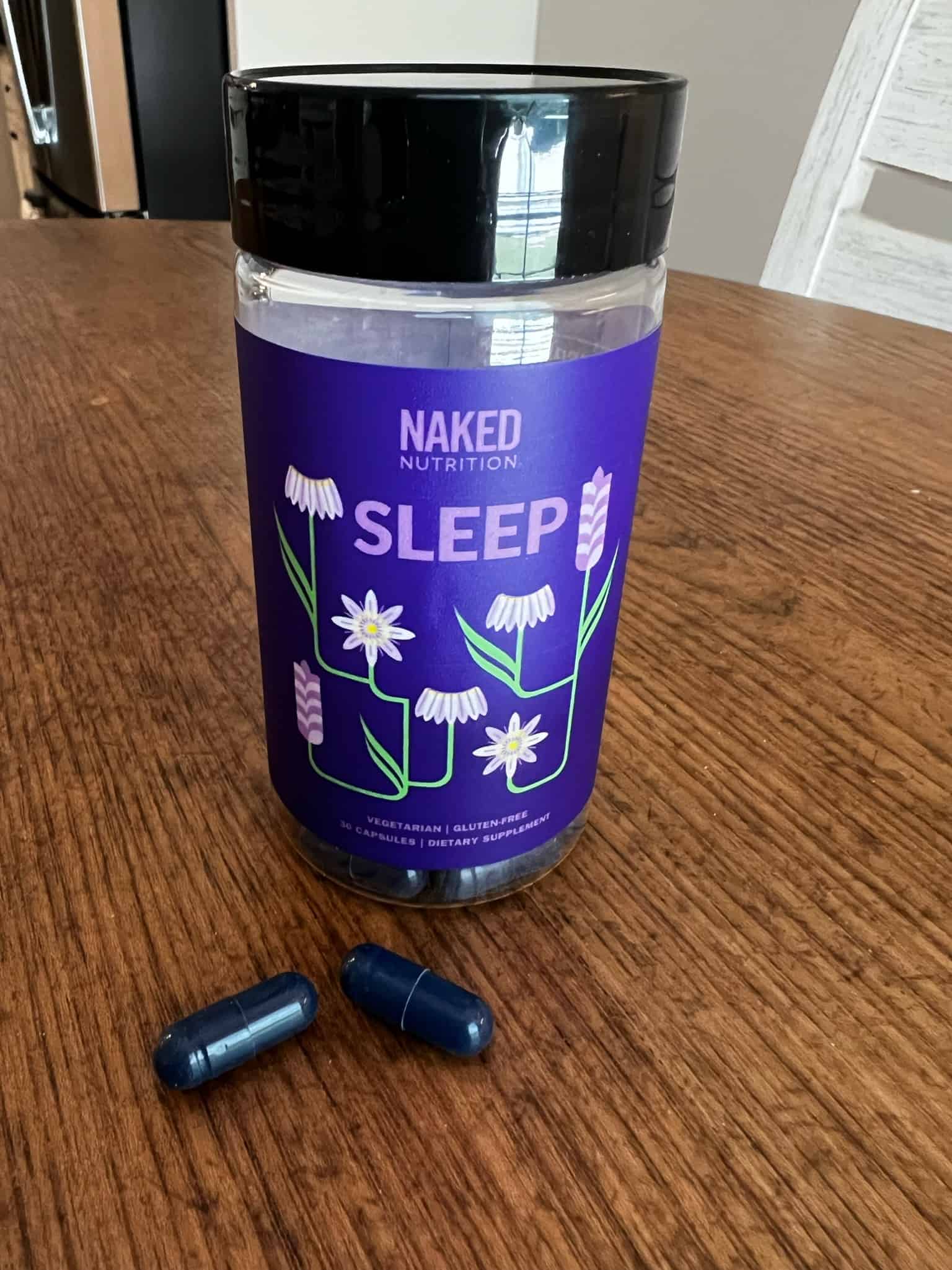 Naked Nutrition Sleep Supplement bottle and capsules on a table