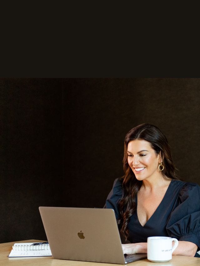 amy porterfield looking at her laptop screen
