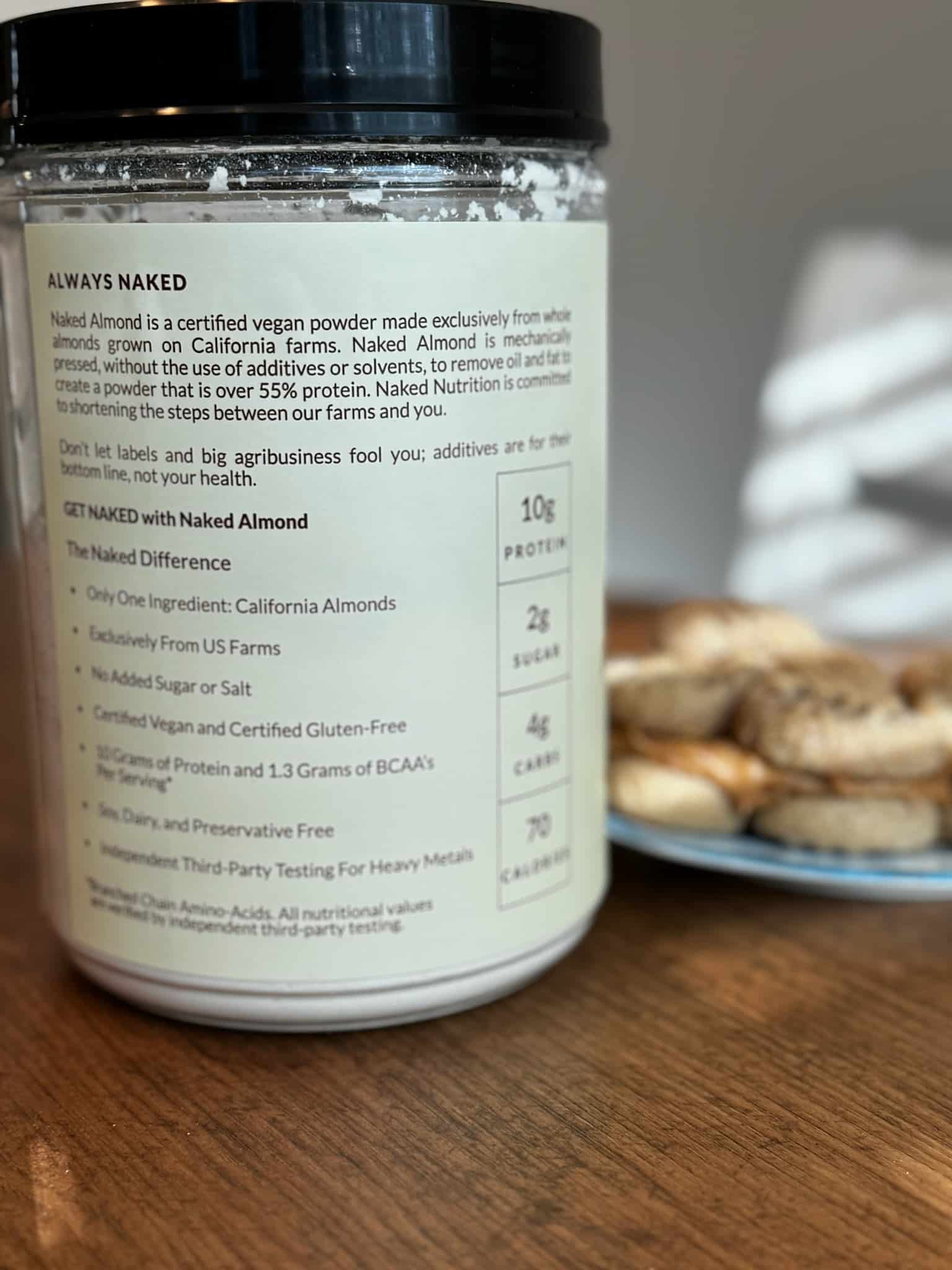 naked nutrition almond powder nutrition label side of container