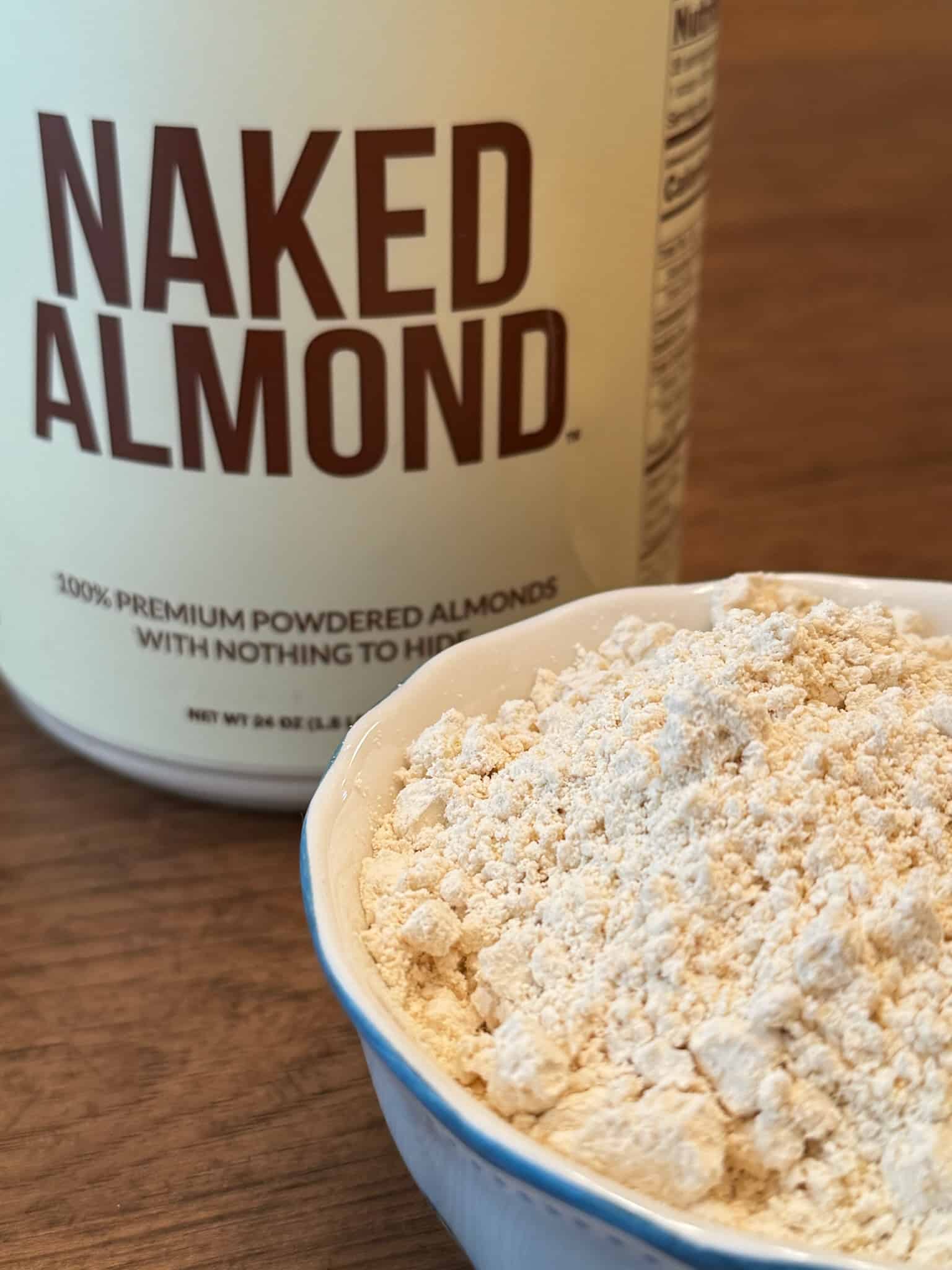 close up of naked almond powder container and in a small bowl