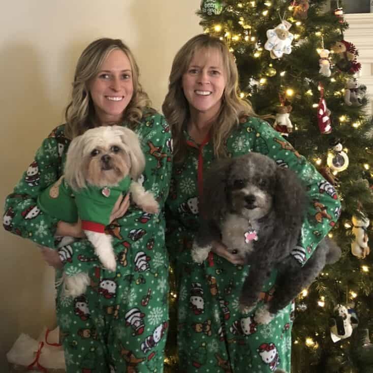 Kim and Kalee with their dogs at Christmas in holiday pajamas