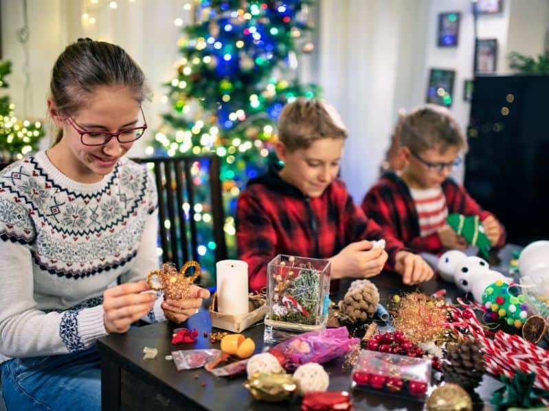 3 kids making Christmas ornaments