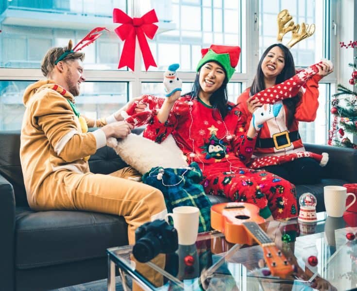 3 friends together in Christmas pajamas after opening presents