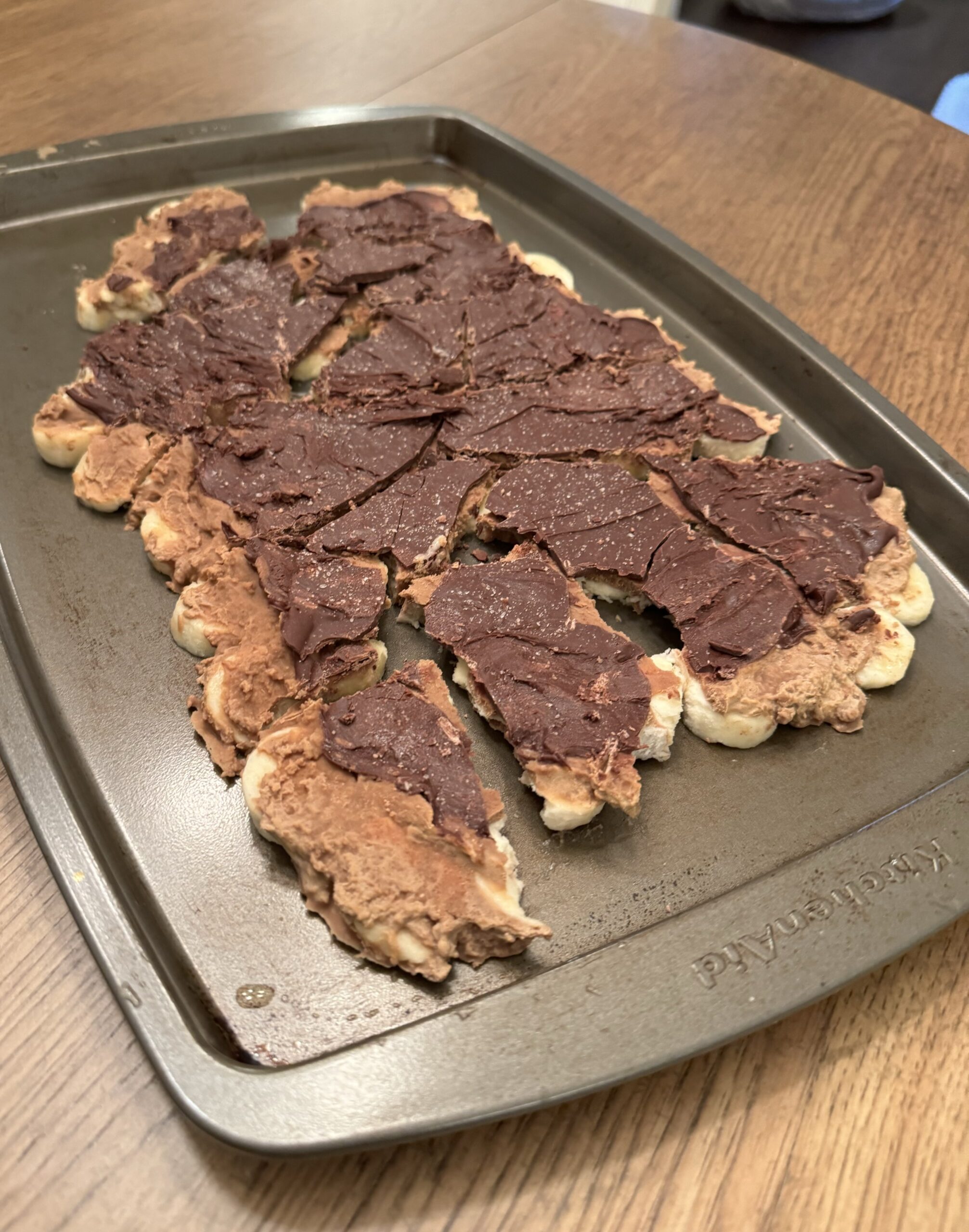 High Protein Chocolate Peanut Butter Banana Bark cut into pieces on a baking sheet