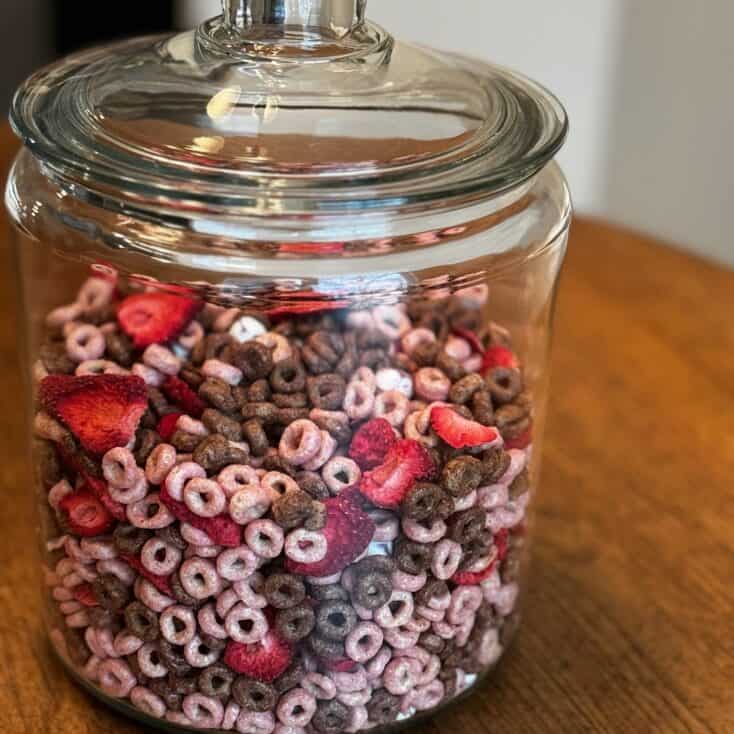 glass jar holding the strawberry snack mix