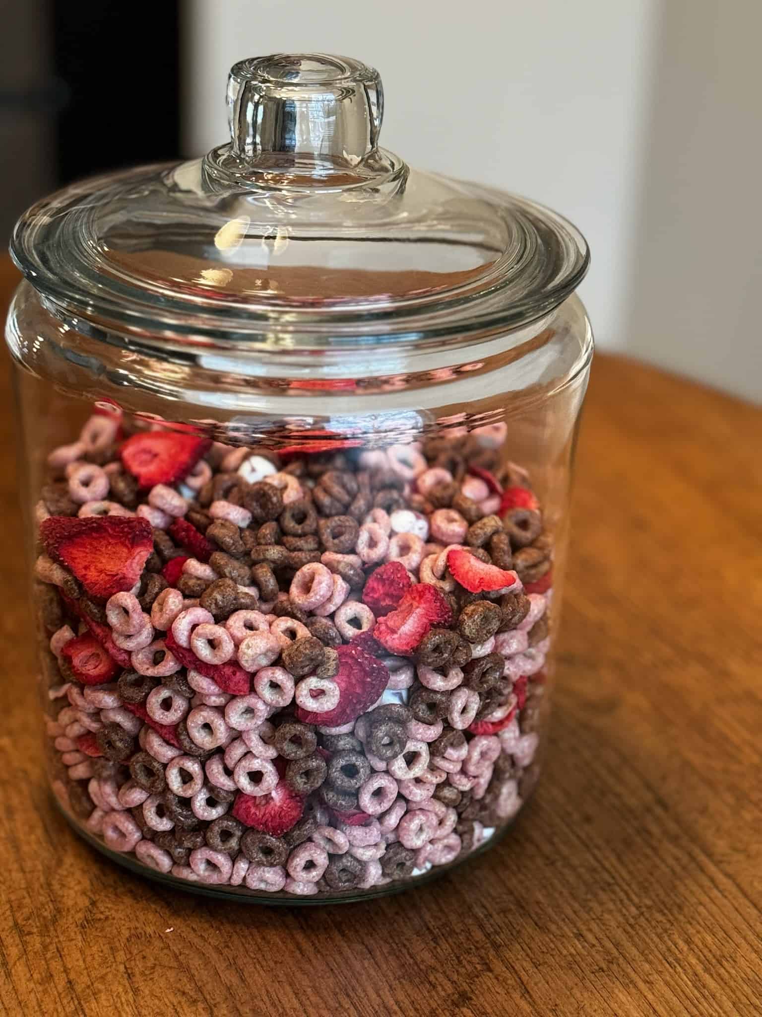 glass jar holding the valentines day snack mix