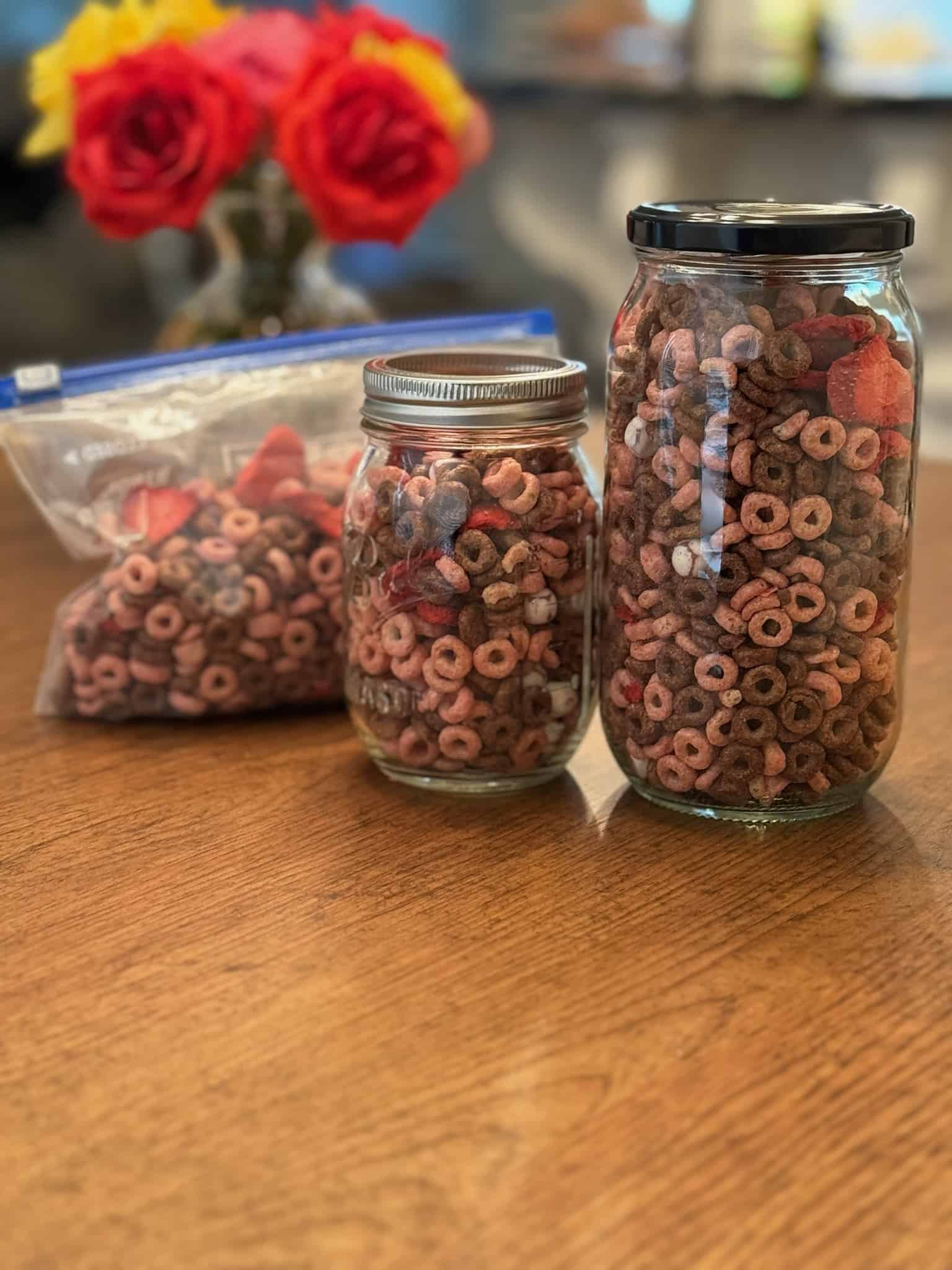 3 different containers with the Valentines Day Snack Mix inside
