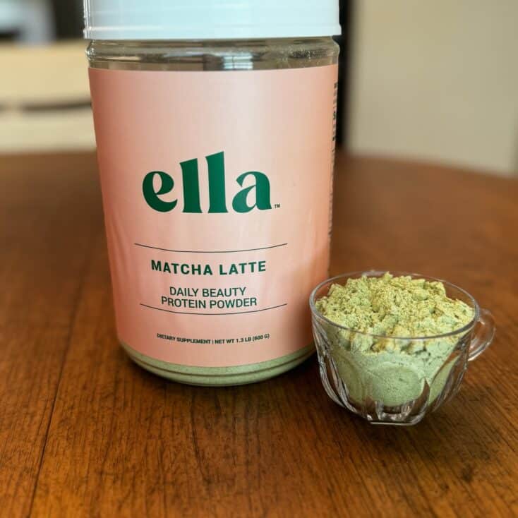 Naked Nutrition's Ella Matcha Latte Collagen Peptides in a glass bowl with the canister beside it