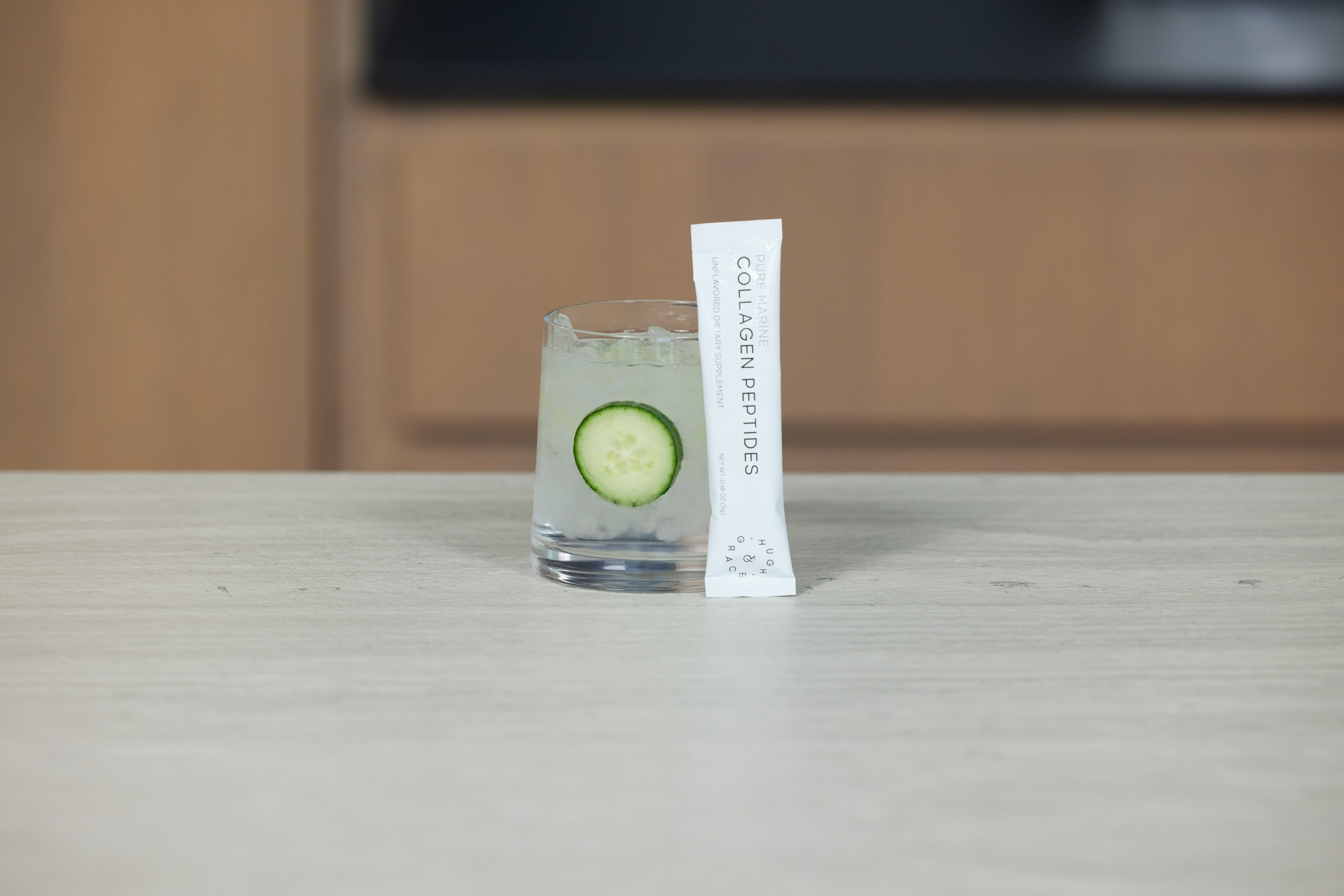 hugh and grace collagen peptides mixed in a glass